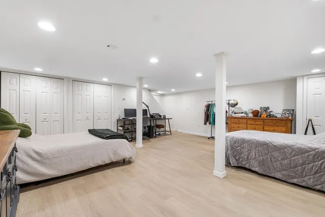 a large bedroom with a bed and lots of large mirror