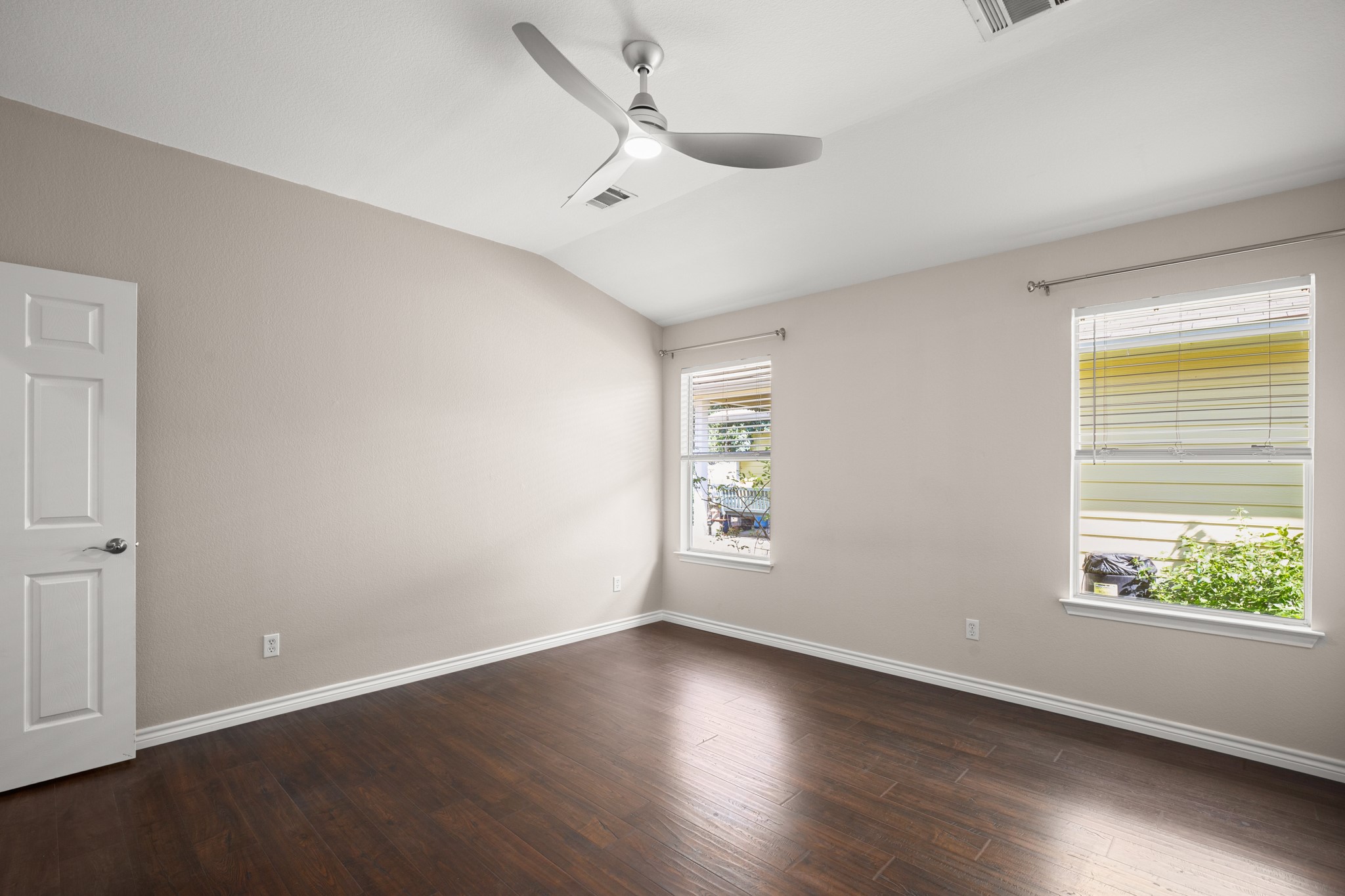 151 Sampson Kyle, TX 78640 - Photo 9 of 23 Soft natural light and tall ceilings keep the primary suite feeling open without losing its cozy side.