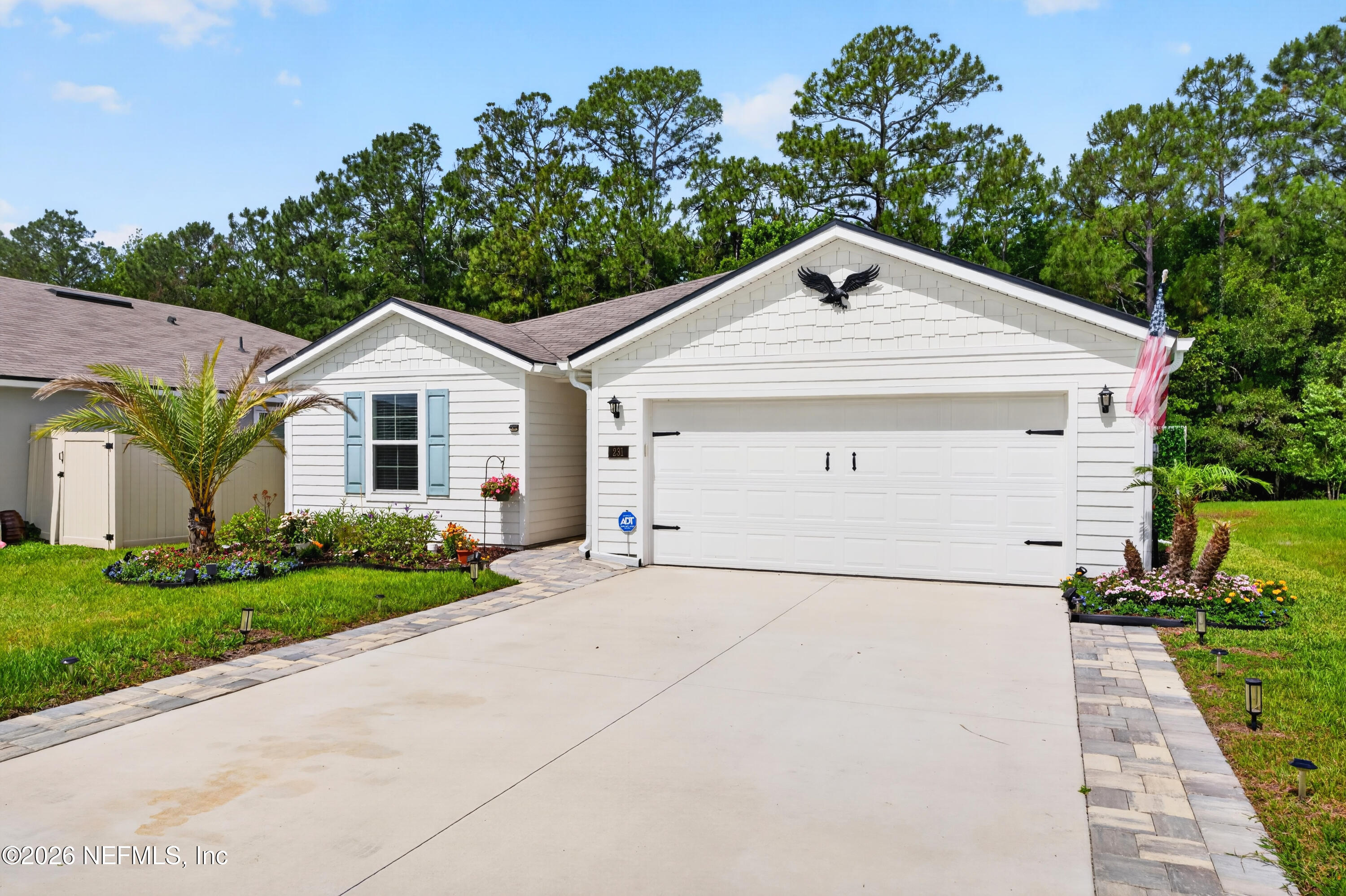 231 Encanto Way Street St. Augustine, FL 32084 - Photo 1 of 36 a view of a white house next to a yard and trees