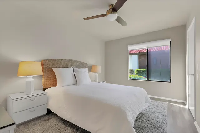 a bedroom with a bed and a painting on the wall