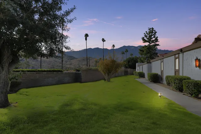 a view of a garden with a building in the background