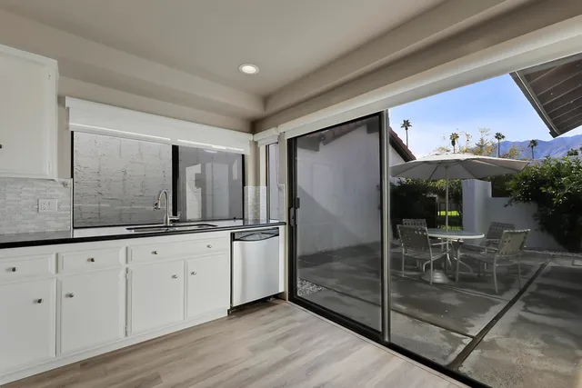 a view of an entryway with wooden floor
