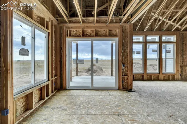 a view of a hallway with wooden floor and entryway