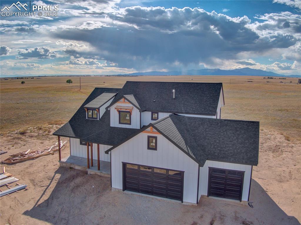 2420 North Log Road Calhan, CO 80808 - Photo 3 of 47 a front view of a house with a yard
