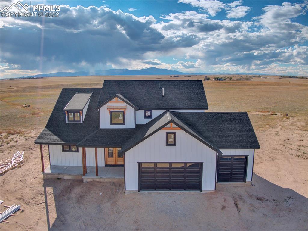 2420 North Log Road Calhan, CO 80808 - Photo 4 of 47 a front view of a house with a yard