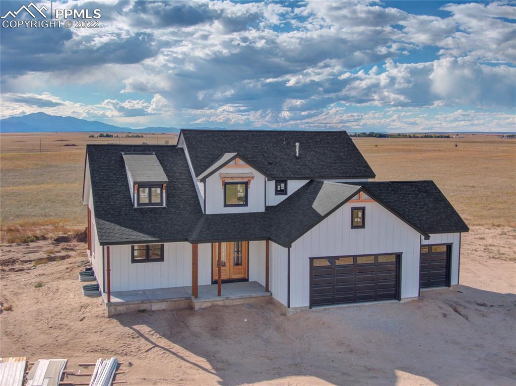 2420 North Log Road Calhan, CO 80808 - Photo 5 of 47 a view of a brick house with many windows
