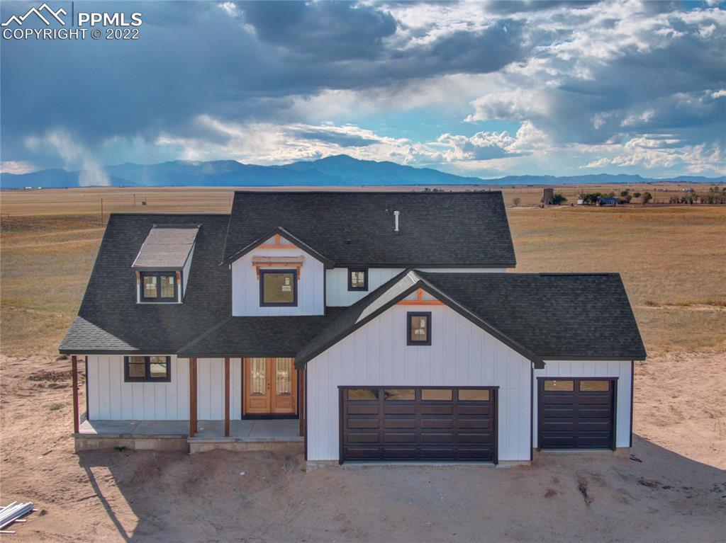 2420 North Log Road Calhan, CO 80808 - Photo 7 of 47 a front view of a house with a yard