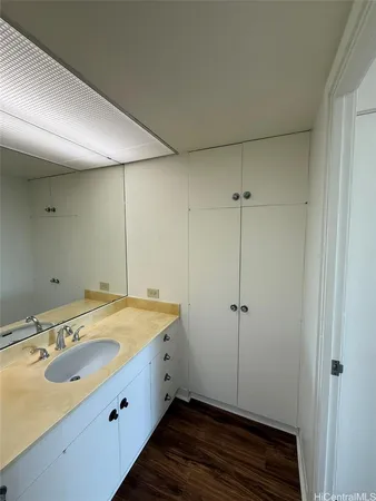 a bathroom with a granite countertop sink and a mirror