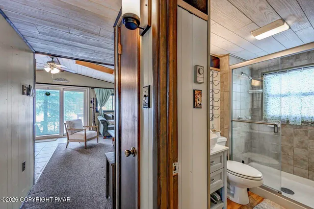 a bed sitting in a spacious bedroom next to a window