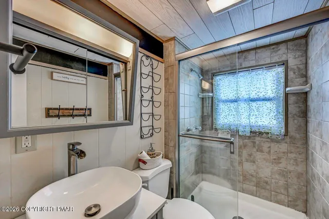 a bedroom with bed and wooden floor