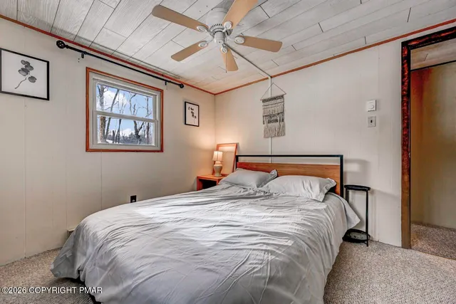 a view of a bedroom with bed and furniture