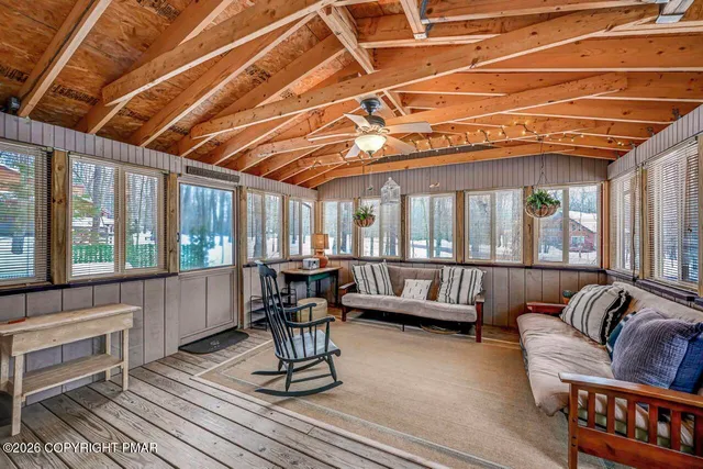 a balcony with furniture and wooden floor