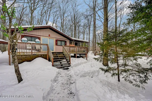 a view of a balcony with wooden floor and staircase