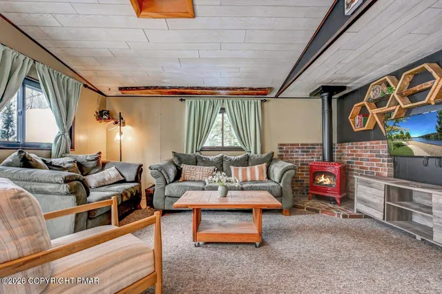 a living room with furniture and a flat screen tv