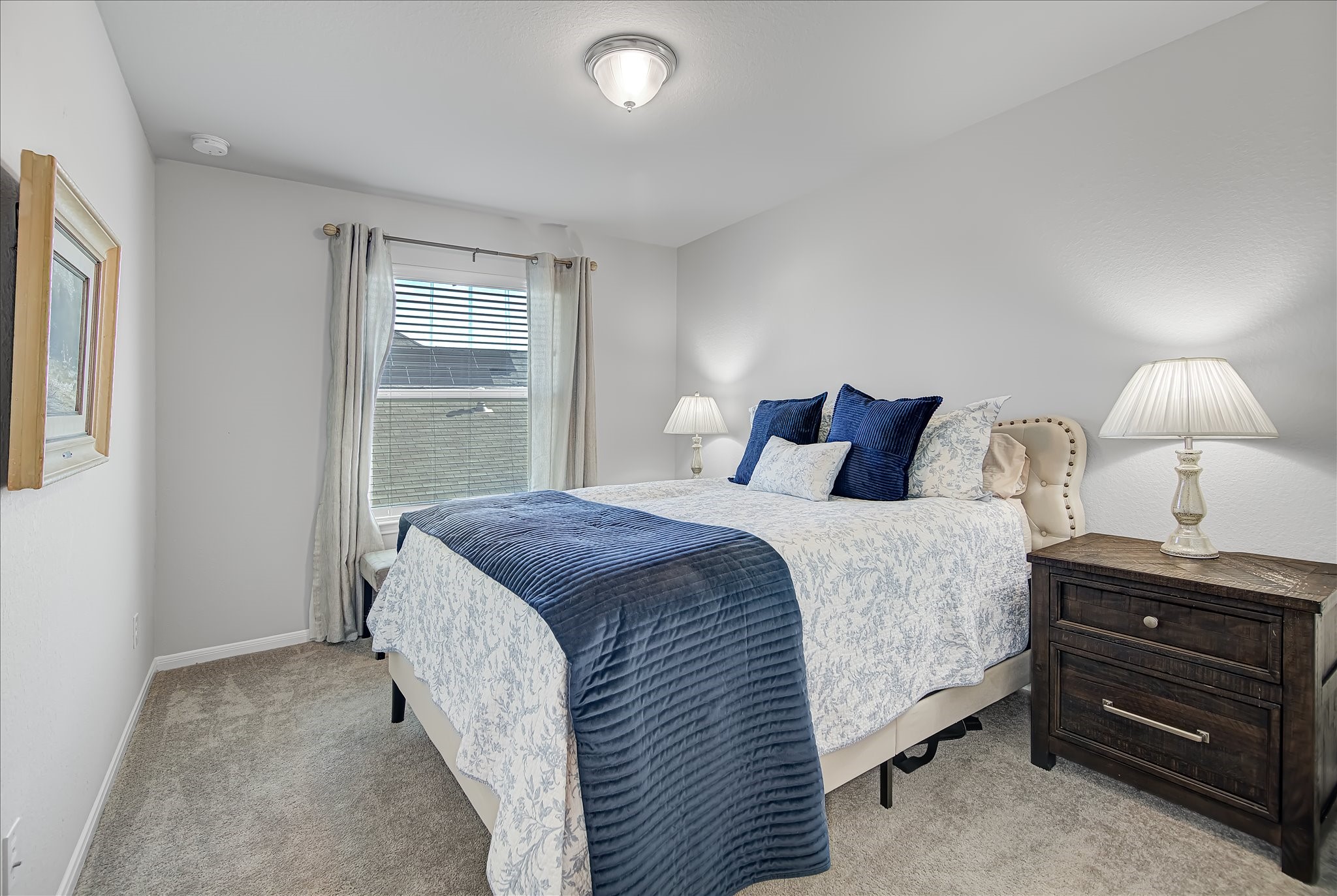 6014 Prince Place Drive Rosenberg, TX 77471 - Photo 17 of 28 Bedroom two offers a comfortable layout with soft carpet, neutral finishes, and great natural light, making it an easy fit for guests, a home office, or a secondary bedroom.