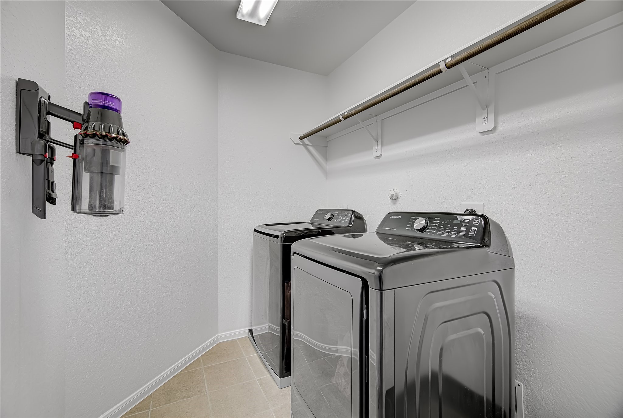 6014 Prince Place Drive Rosenberg, TX 77471 - Photo 21 of 28 The dedicated laundry room offers convenient shelving, space for full-size appliances, and includes the washer and dryer, helping keep daily routines organized and easy.