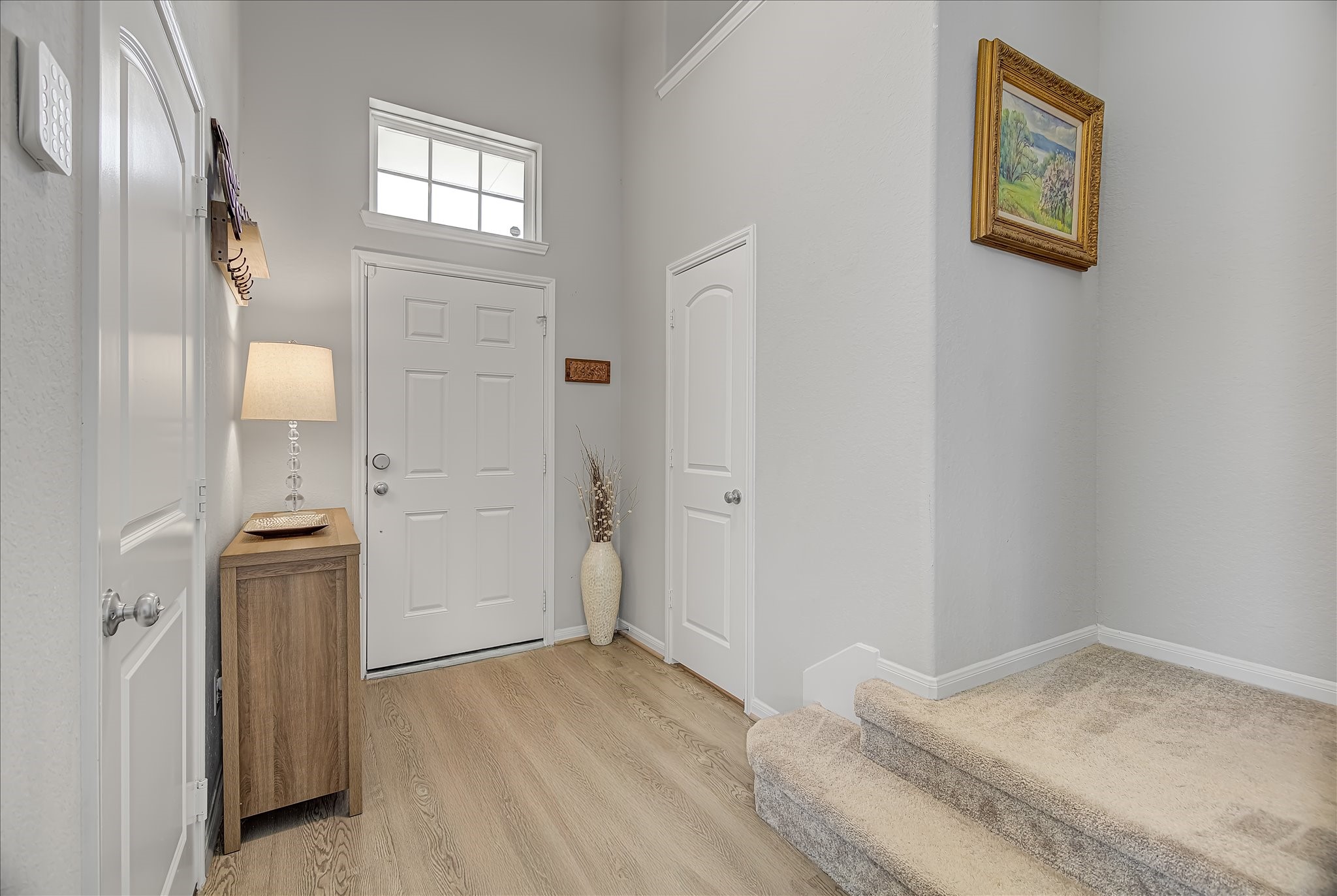 6014 Prince Place Drive Rosenberg, TX 77471 - Photo 4 of 28 Step inside to a bright foyer with neutral finishes and durable vinyl plank flooring that flows easily into the main living areas.