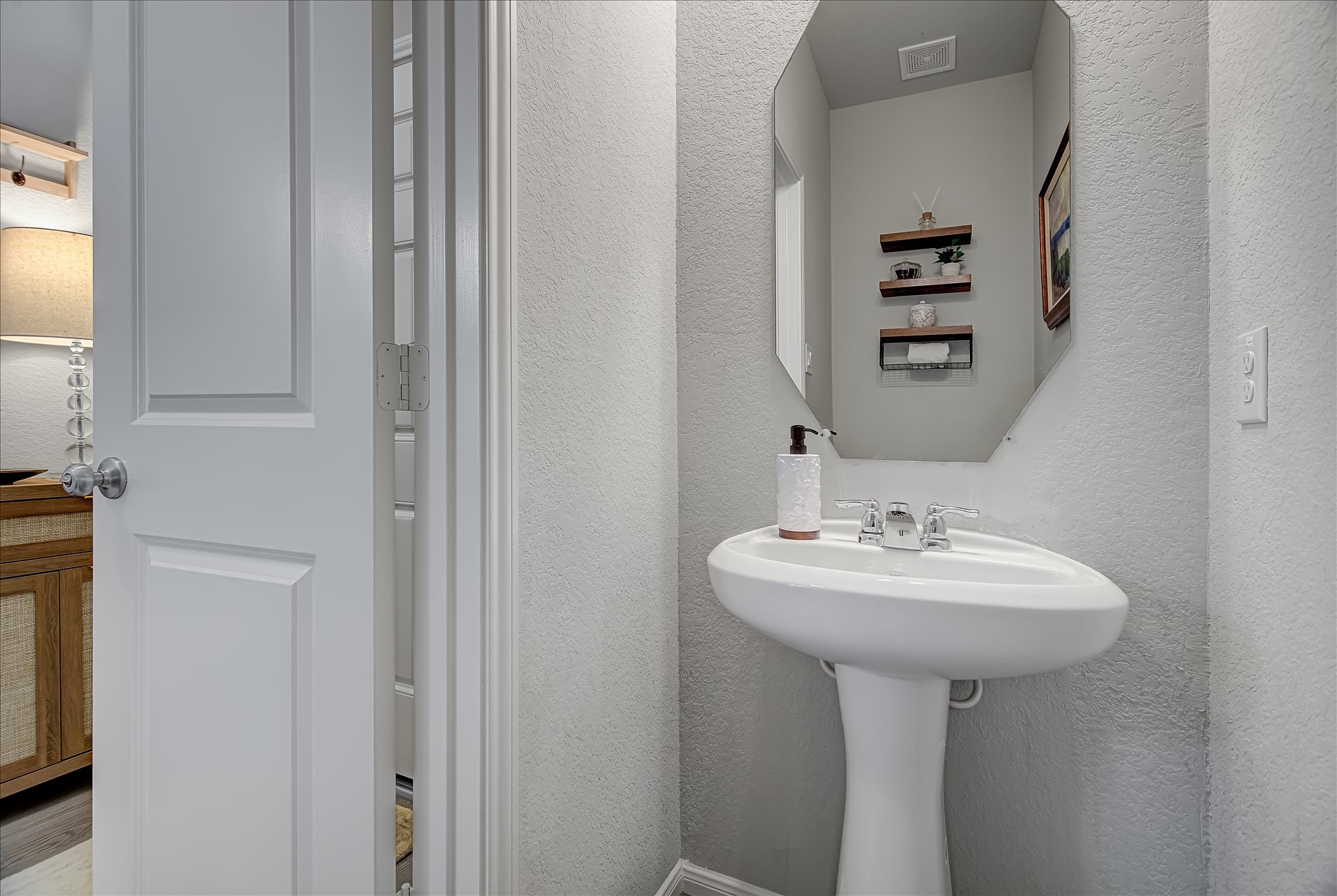 6014 Prince Place Drive Rosenberg, TX 77471 - Photo 5 of 28 The conveniently located half bath is perfect for guests and features a pedestal sink, updated fixtures, and a fresh, clean look.