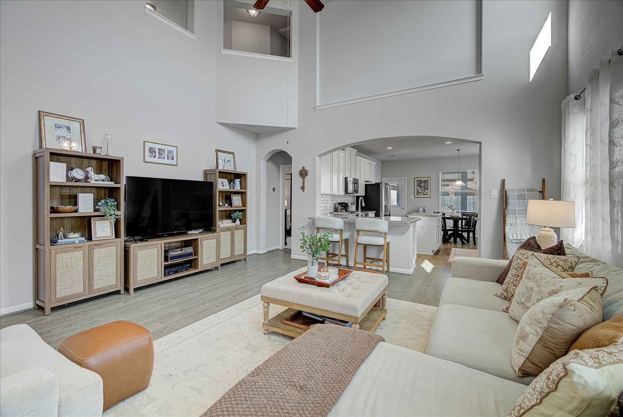 6014 Prince Place Drive Rosenberg, TX 77471 - Photo 7 of 28 This view highlights how the family room connects seamlessly to the kitchen and dining areas, making the layout ideal for entertaining and everyday living.