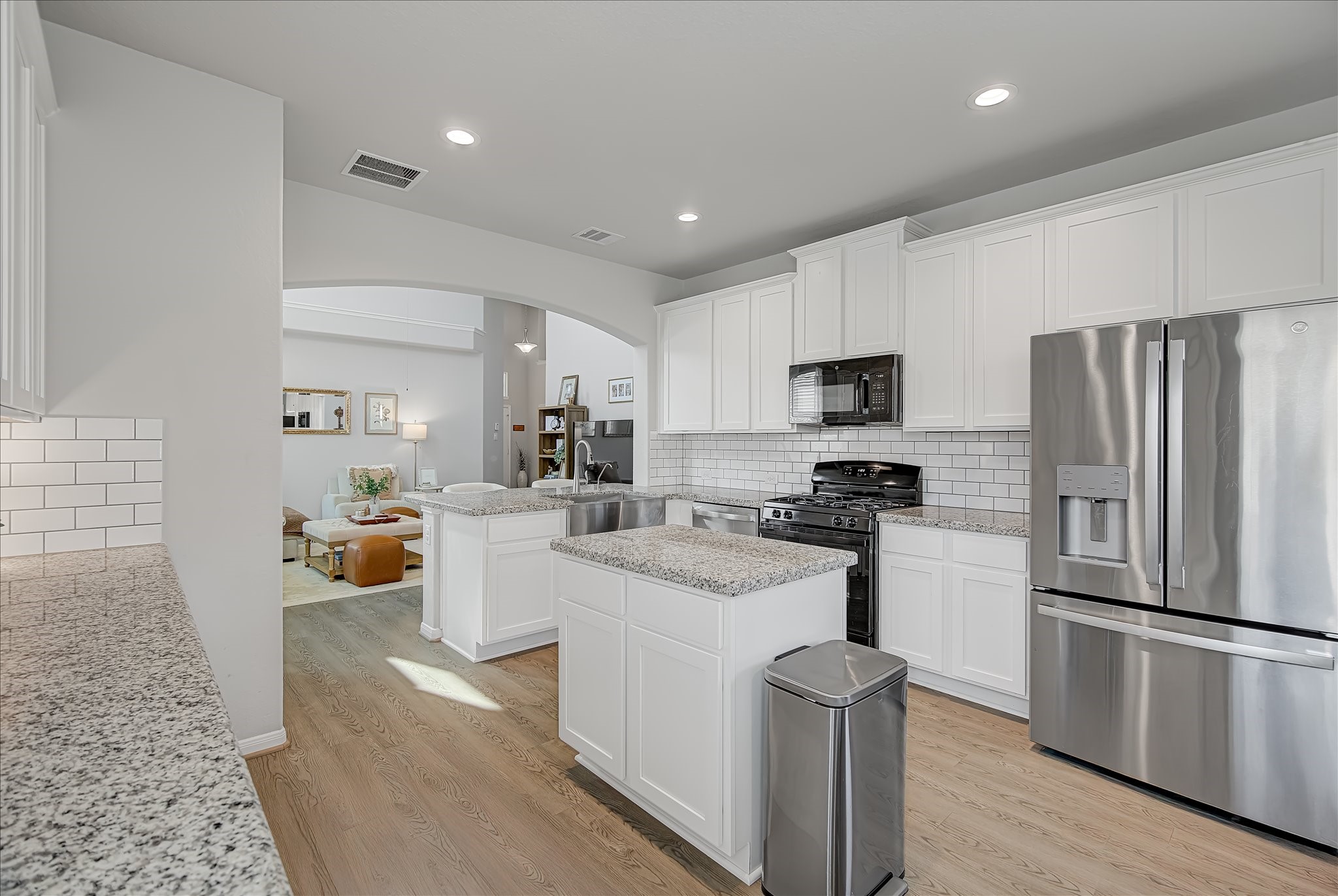 6014 Prince Place Drive Rosenberg, TX 77471 - Photo 9 of 28 Designed with both style and function in mind, the kitchen features a farmhouse sink, stainless steel appliances, generous storage, and a brand-new dishwasher installed in 2025.