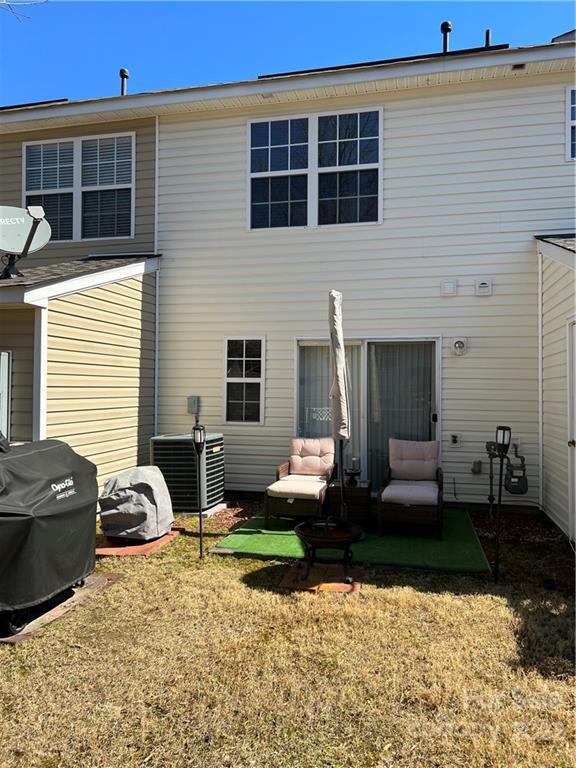 11222 Grass Field Road Charlotte, NC 28213 - Photo 11 of 12 a view of a patio with couches chairs and potted plants