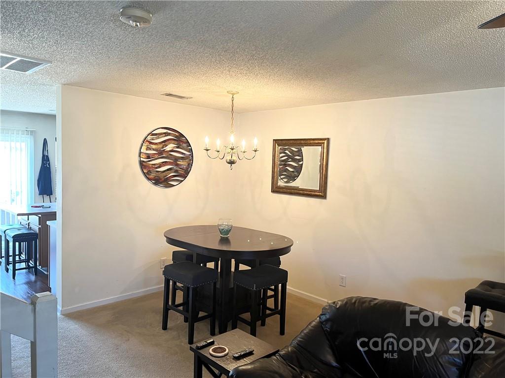 11222 Grass Field Road Charlotte, NC 28213 - Photo 3 of 12 a view of a room with a table and chairs