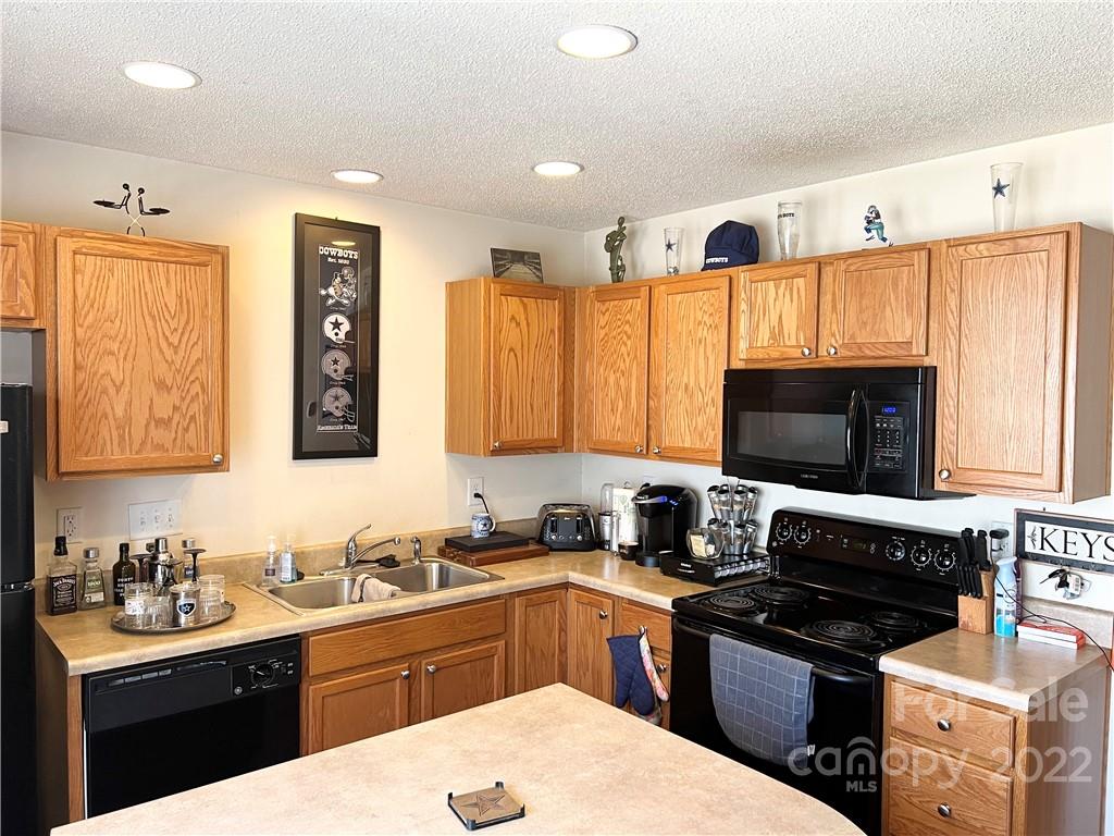 11222 Grass Field Road Charlotte, NC 28213 - Photo 4 of 12 a kitchen with a sink stove top oven and microwave