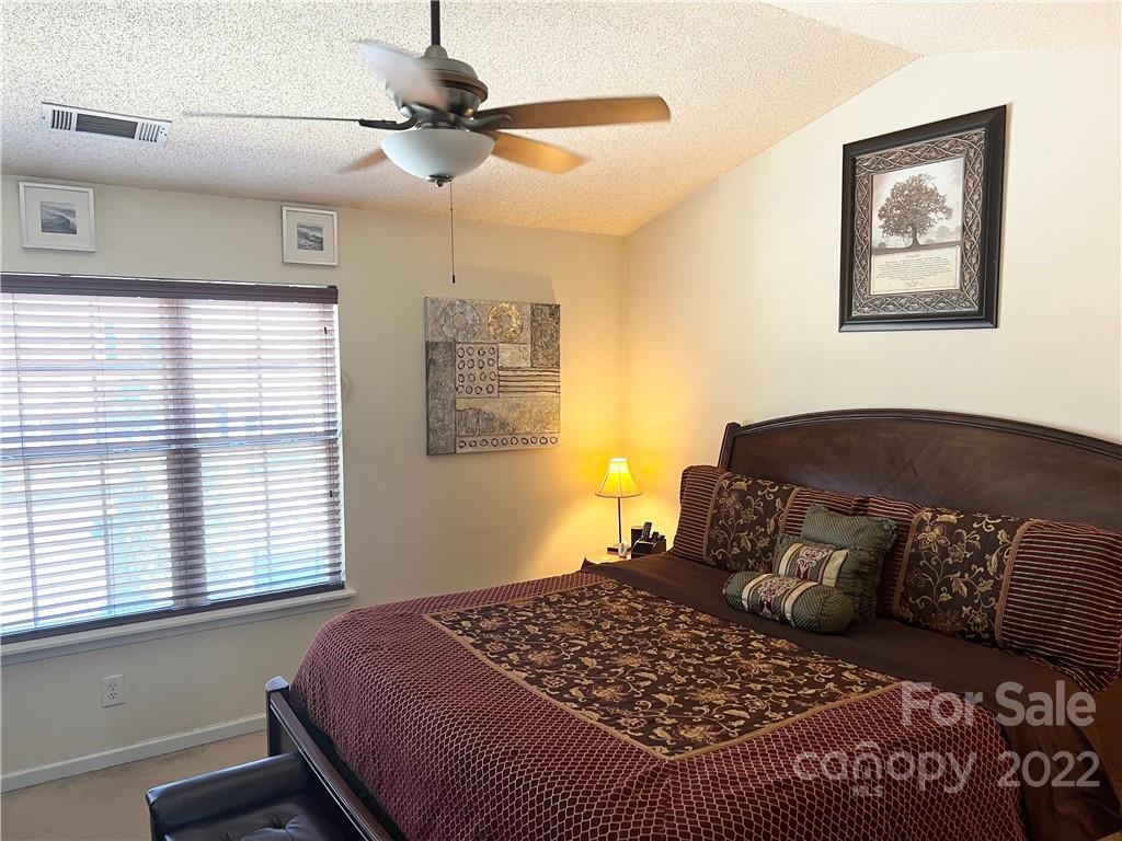 11222 Grass Field Road Charlotte, NC 28213 - Photo 8 of 12 a bedroom with a large bed and a window