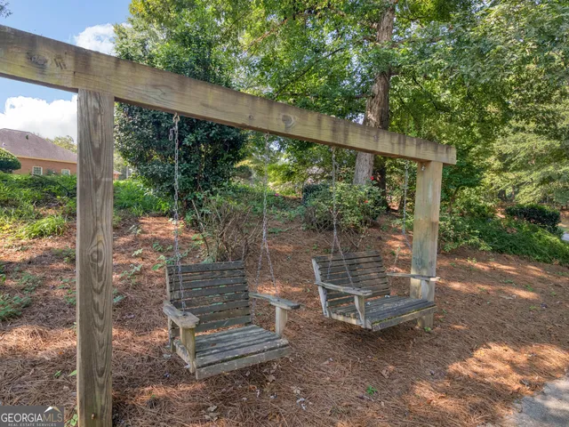 a view of balcony with wooden floor and fence