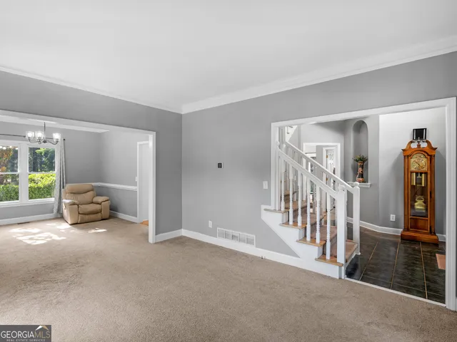 a view of livingroom with furniture and staircase