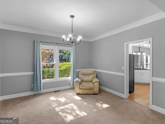 a view of a livingroom with furniture wooden floor and chandelier