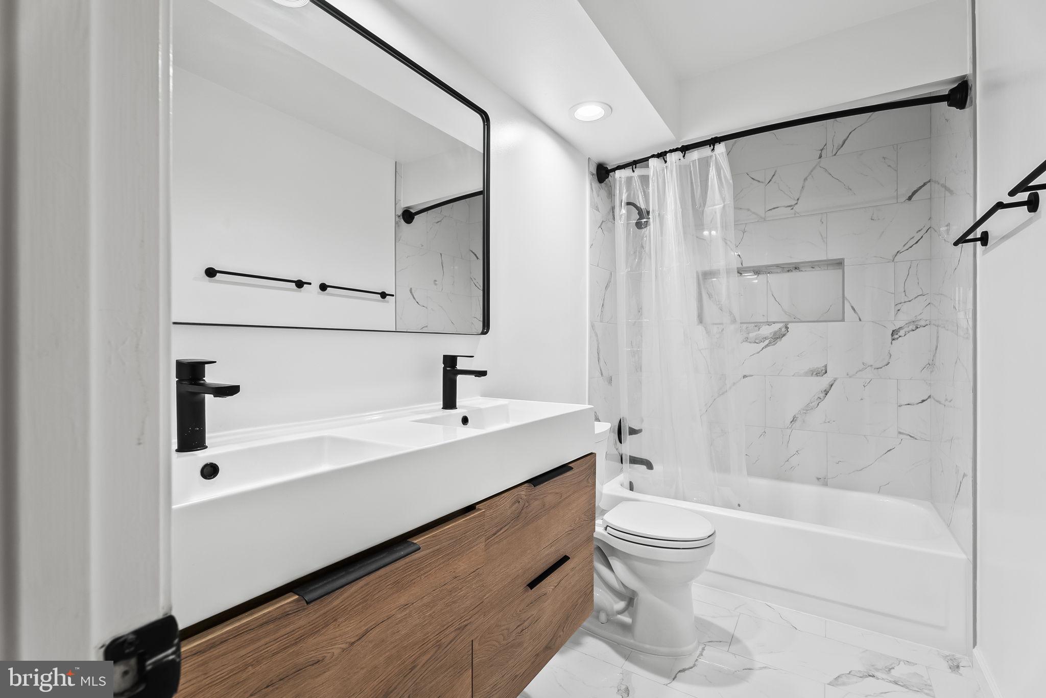 1989 Bowline Loop Woodbridge, VA 22192 - Photo 16 of 30 a bathroom with a bathtub shower sink vanity and toilet