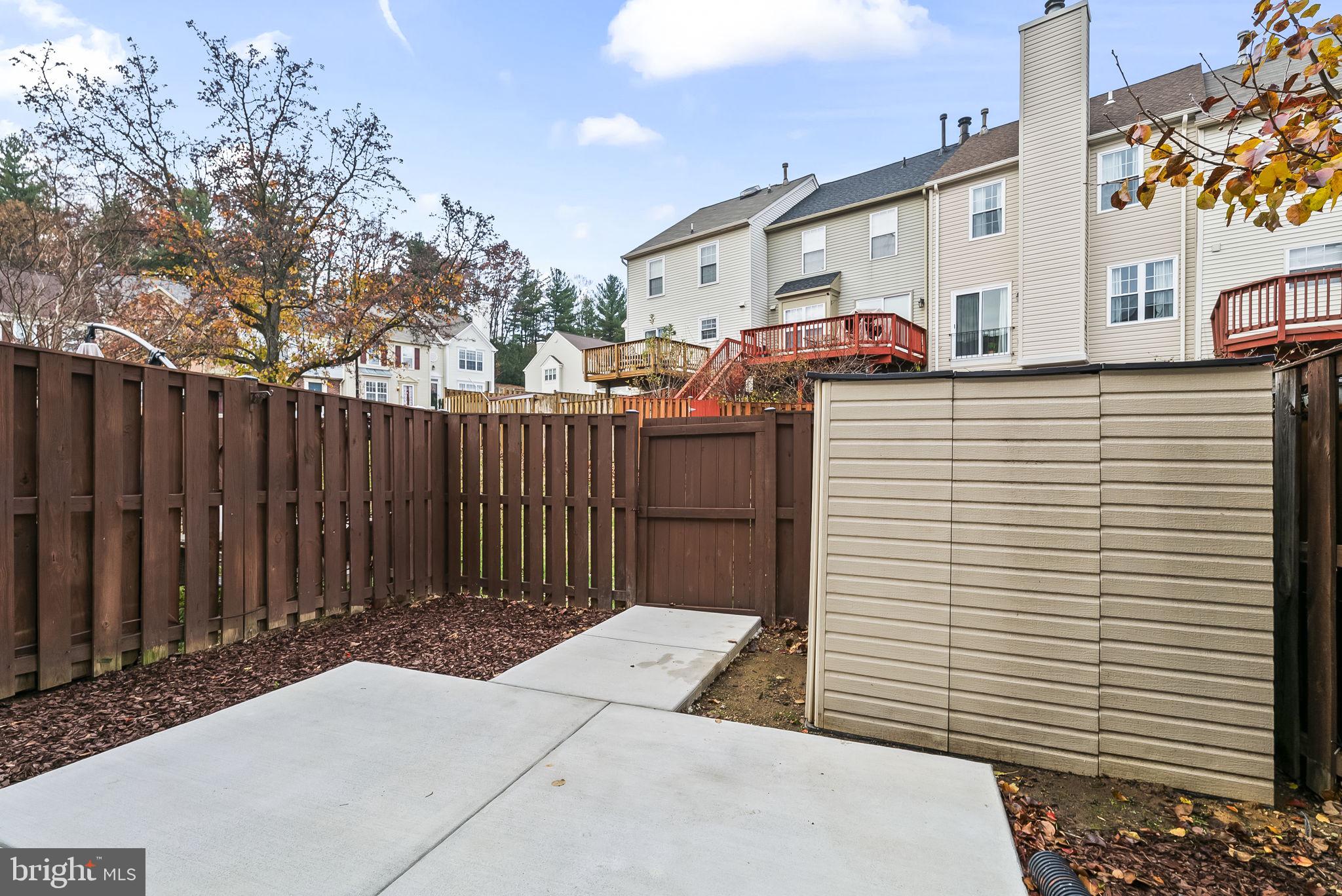 1989 Bowline Loop Woodbridge, VA 22192 - Photo 26 of 30 a view of a patio with table and chairs with wooden fence