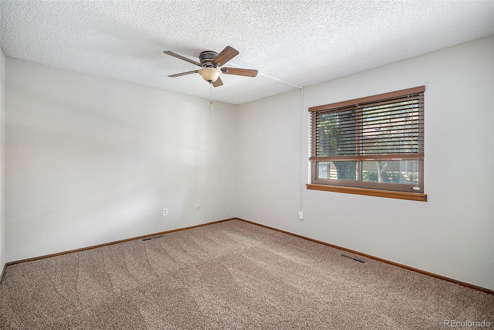 136 South Eagle Circle Aurora, CO 80012 - Photo 17 of 23 a view of an empty room with a window