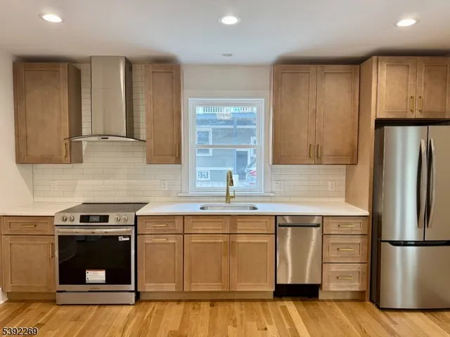 a kitchen with a sink stove and refrigerator