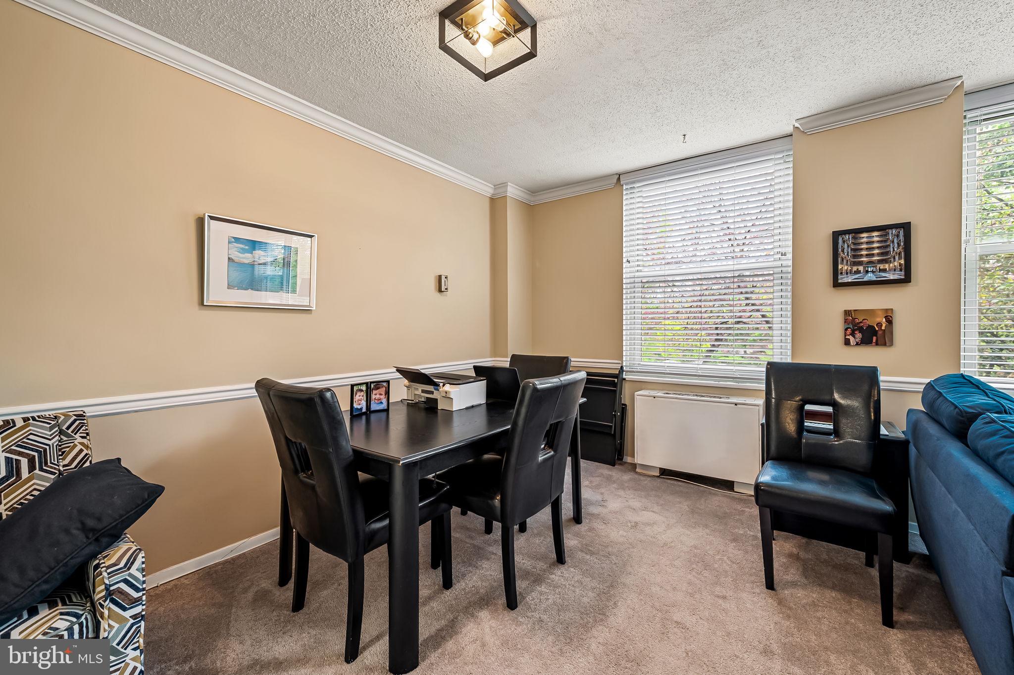 4401 Roland Avenue, Unit 110 Baltimore, MD 21210 - Photo 11 of 23 a view of a dining room with furniture and a window