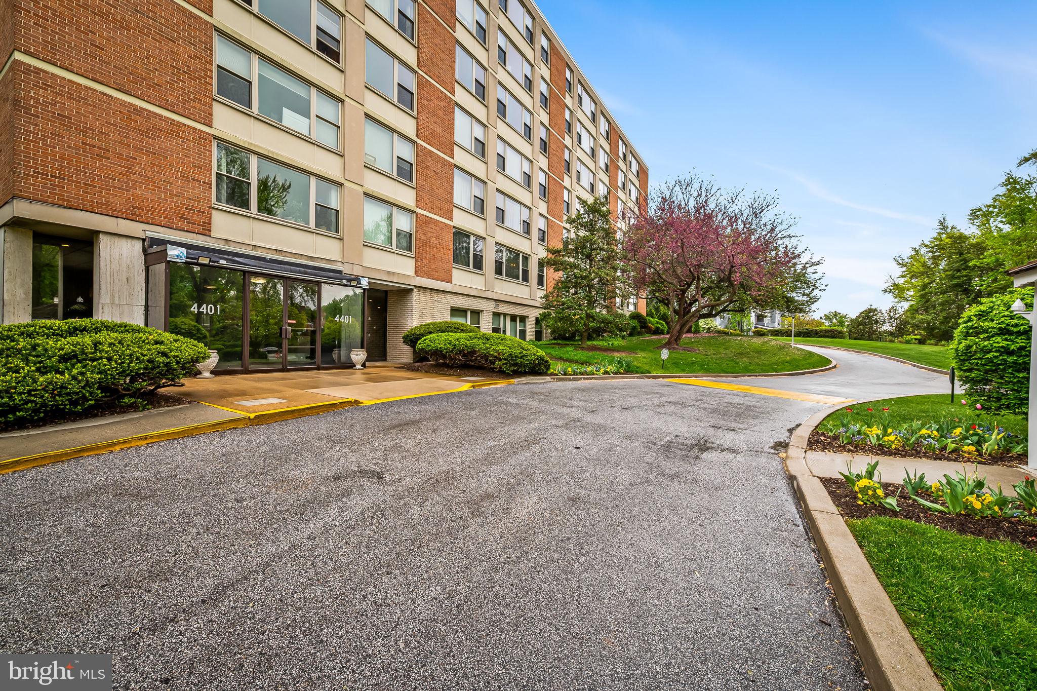 4401 Roland Avenue, Unit 110 Baltimore, MD 21210 - Photo 3 of 23 a view of building with yard and trees in the background