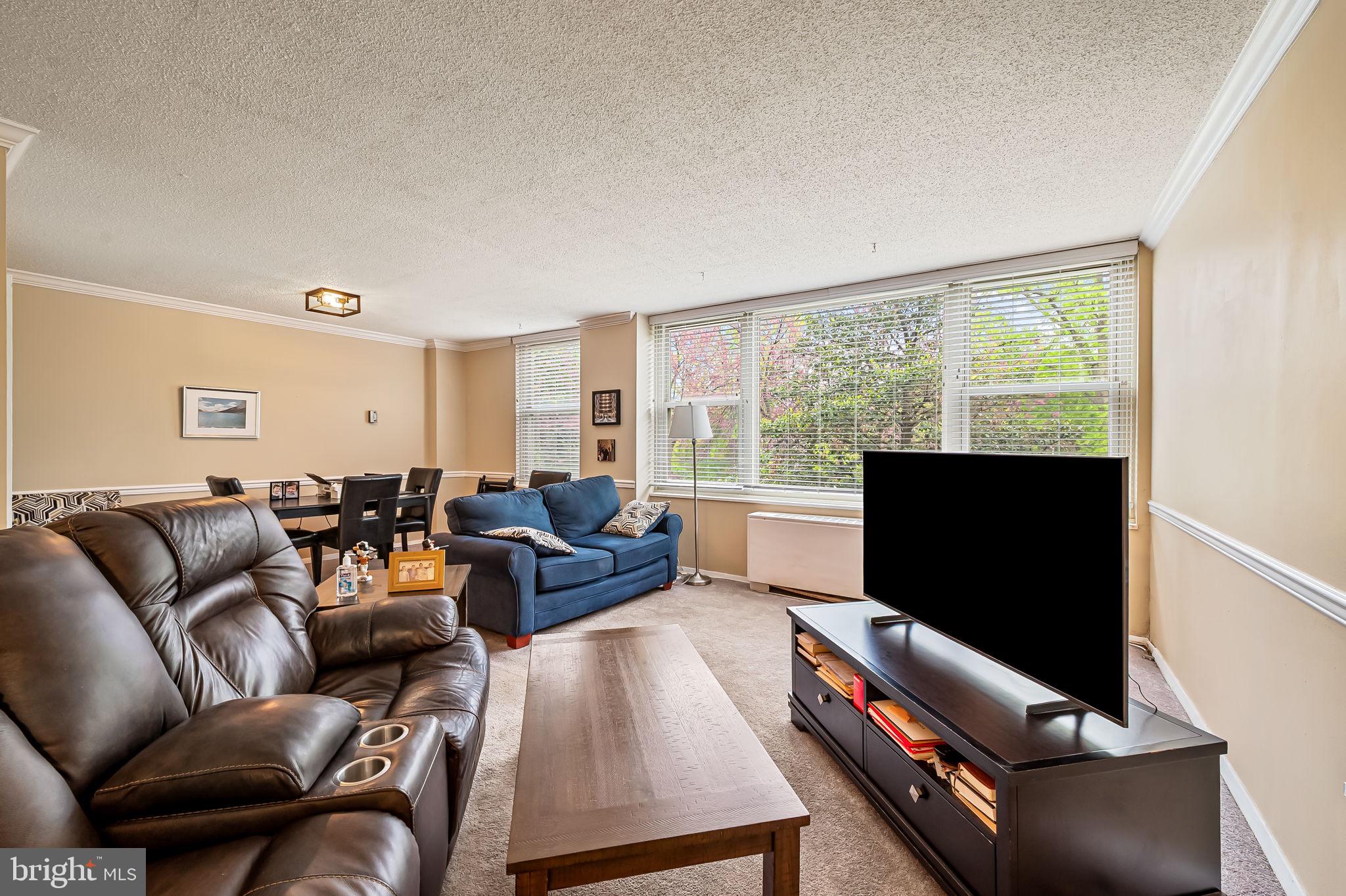 4401 Roland Avenue, Unit 110 Baltimore, MD 21210 - Photo 7 of 23 a living room with furniture and a flat screen tv