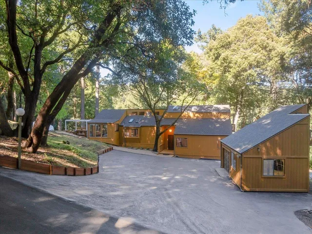 a view of backyard with trees and a barn
