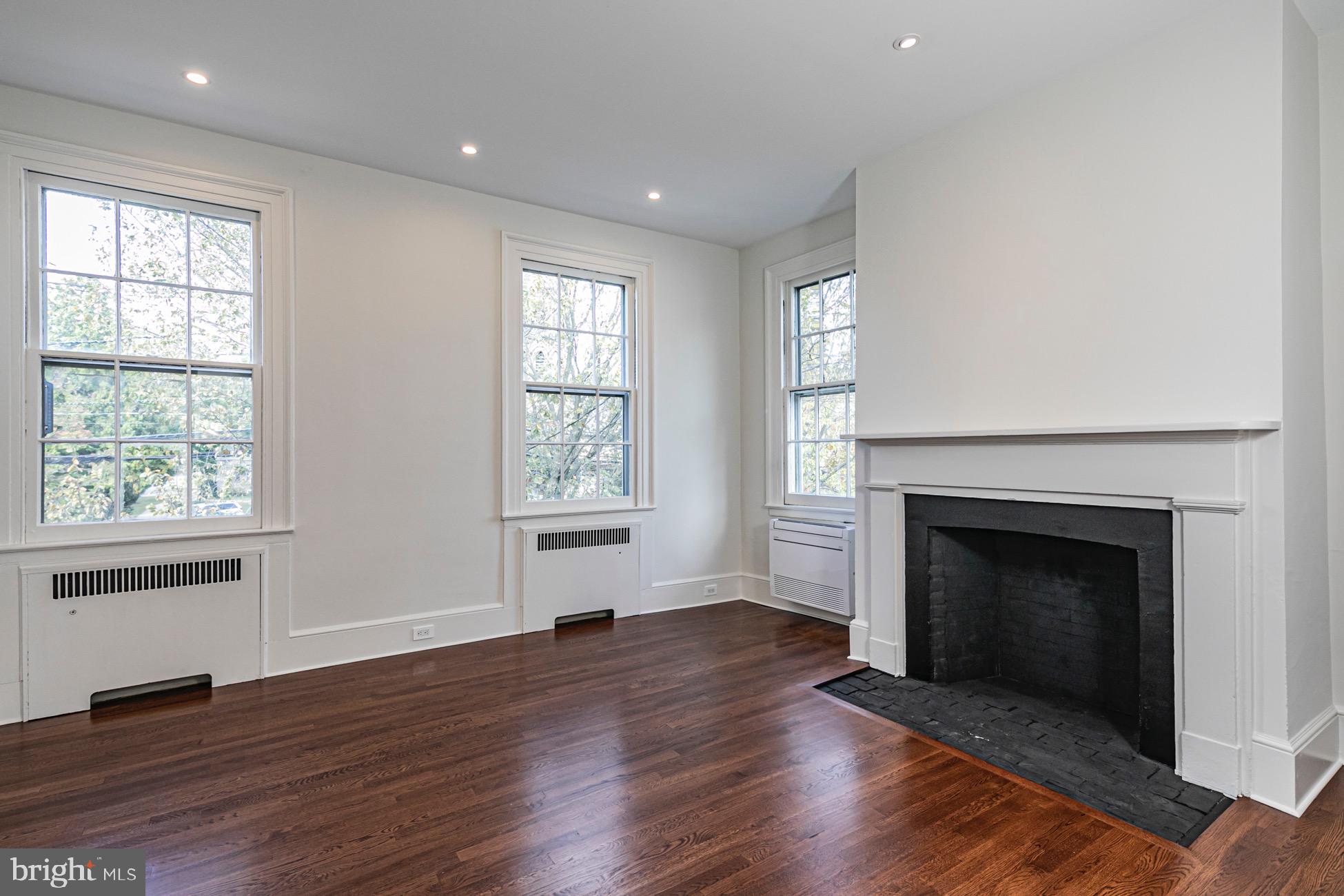 40 Mercer Street Princeton, NJ 08540 - Photo 16 of 35 an empty room with wooden floor fireplace and windows