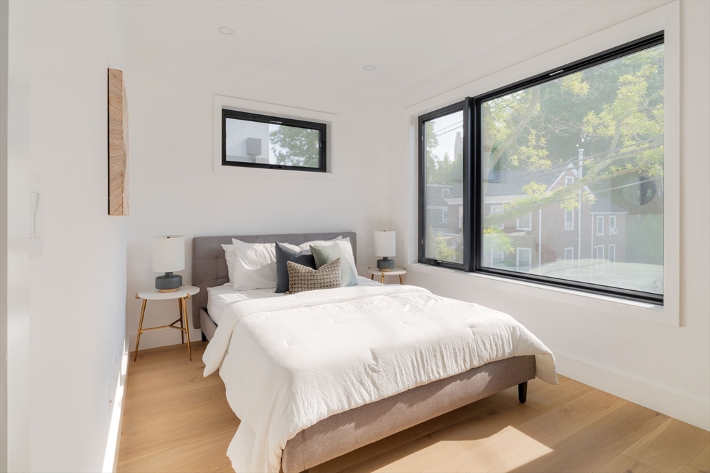 2 Soden Street, Unit 2 Cambridge, MA 02139 - Photo 12 of 38 a bedroom with a large bed and a large window