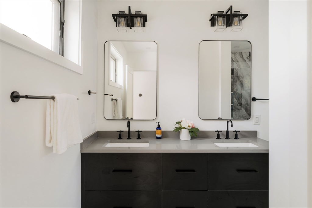 2 Soden Street, Unit 2 Cambridge, MA 02139 - Photo 20 of 38 a bathroom with double vanity sinks and a mirror