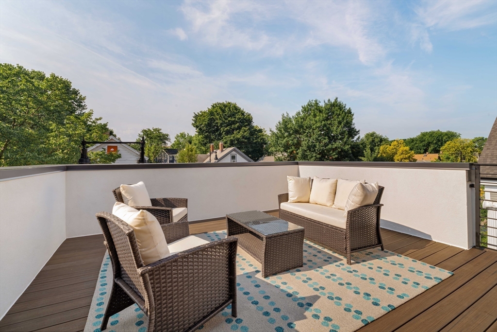 2 Soden Street, Unit 2 Cambridge, MA 02139 - Photo 23 of 38 a view of a chair and table on the deck