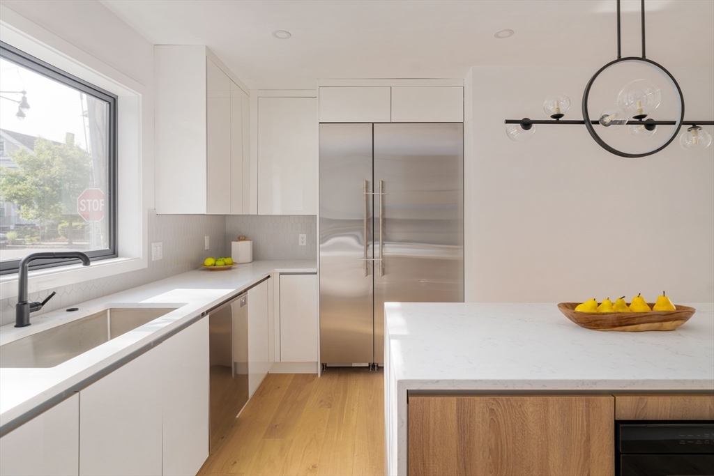 2 Soden Street, Unit 2 Cambridge, MA 02139 - Photo 10 of 38 a kitchen with a sink and a refrigerator