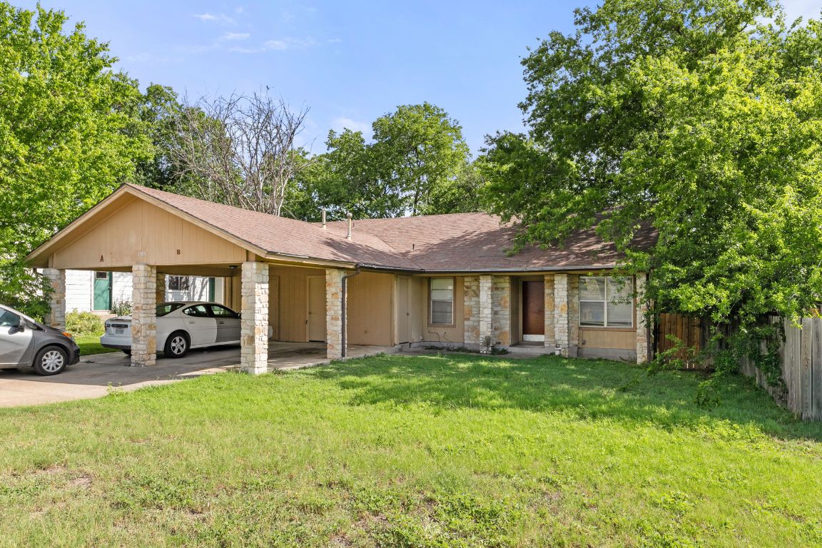 818 Sirocco Drive, Unit B Austin, TX 78745 - Photo 1 of 34 a front view of a house with a yard and garage