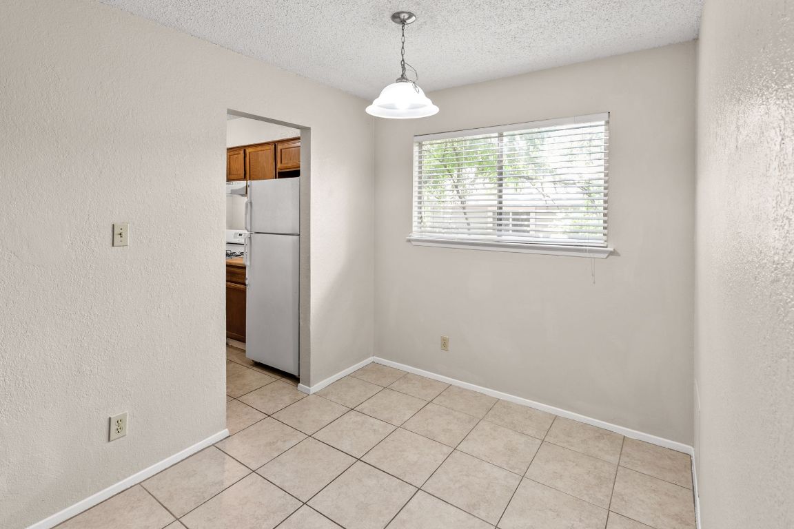 818 Sirocco Drive, Unit B Austin, TX 78745 - Photo 12 of 34 an empty room with windows and cabinet