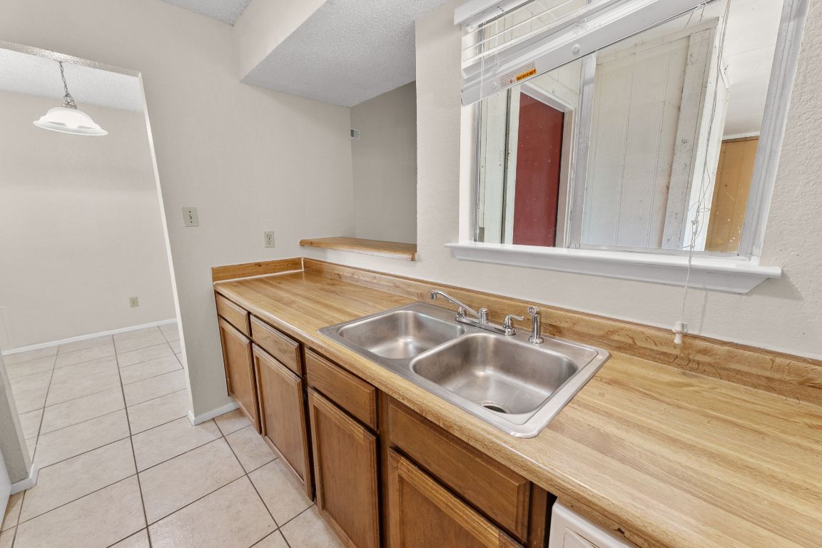 818 Sirocco Drive, Unit B Austin, TX 78745 - Photo 13 of 34 a sink and dishwasher with a vanity