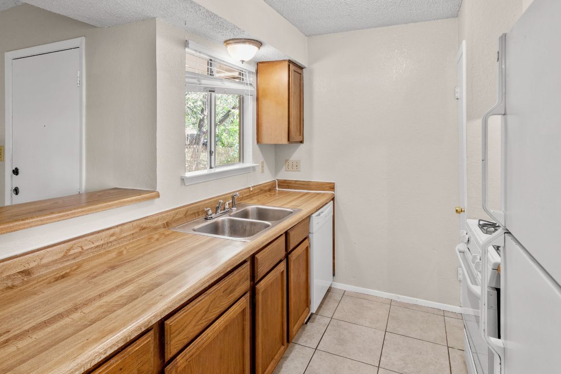 818 Sirocco Drive, Unit B Austin, TX 78745 - Photo 14 of 34 a bathroom with a sink and a window