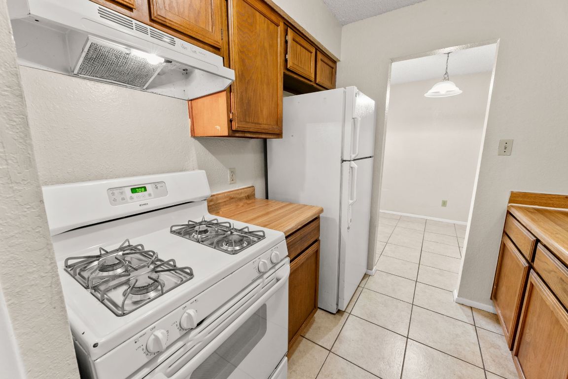 818 Sirocco Drive, Unit B Austin, TX 78745 - Photo 16 of 34 a kitchen with a stove a refrigerator and a cabinets