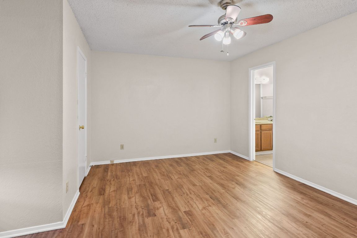 818 Sirocco Drive, Unit B Austin, TX 78745 - Photo 17 of 34 wooden floor in an empty room with a window